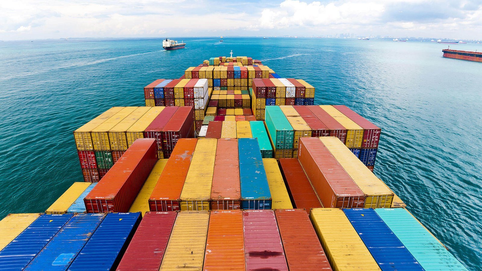 Container vessel loaded with shipping containers at sea